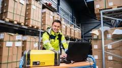 person working on a laptop in a warehouse